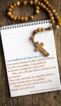 antique rosary beads and blank notebook